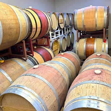 Brown and tan wine barrels stacked on racks