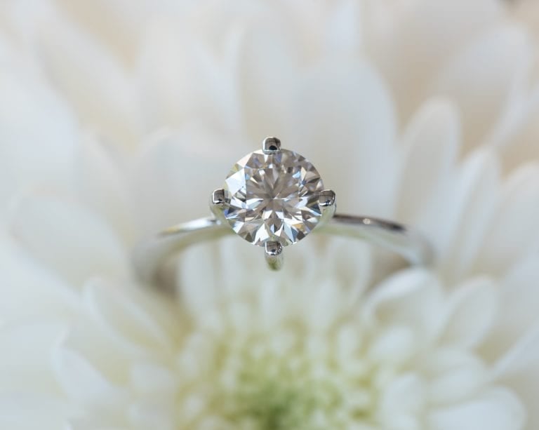 a Lab-Grown Diamonds cut CVD diamond ring with a diamond ring on top of a white flower
