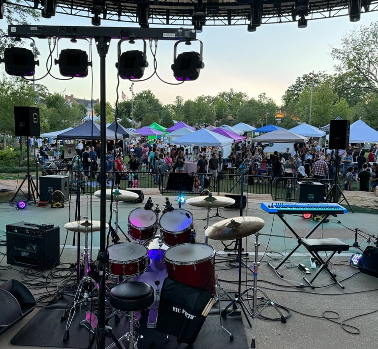 Cary Night Market Vendors and customers behind band set-up on stage