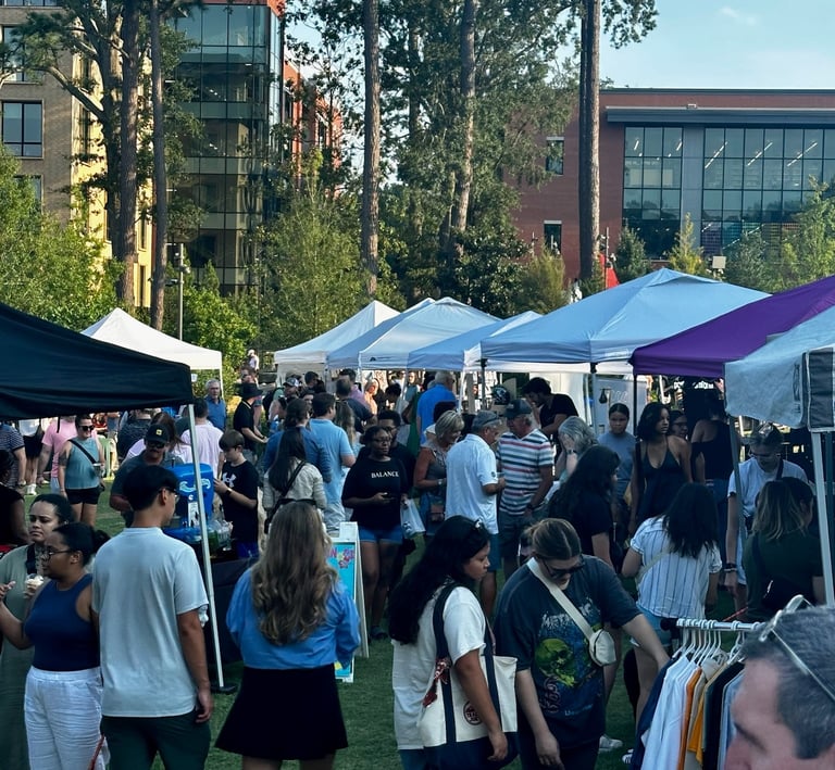 Cary Night Market with vendor tents and customers walking through a crowded area