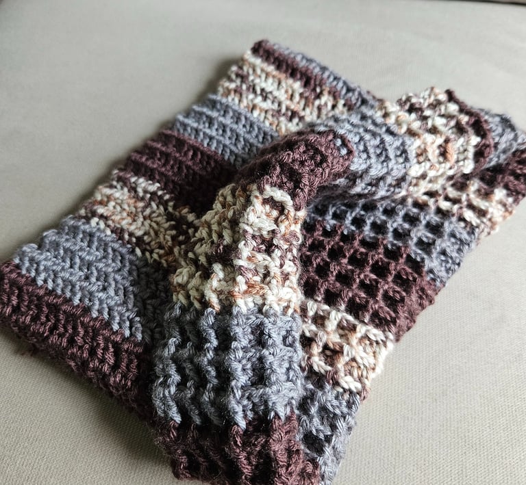 a neutral colored crochet cowl