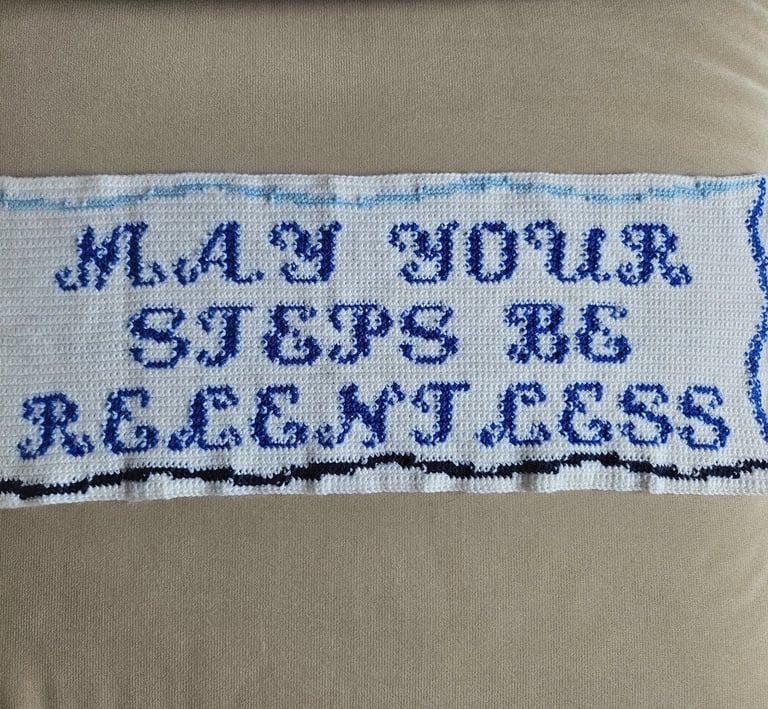 a crochet tapestry on a couch