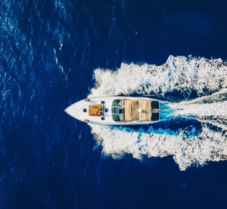 Aerial view of luxury motorboat cruising in blue Sicilian waters