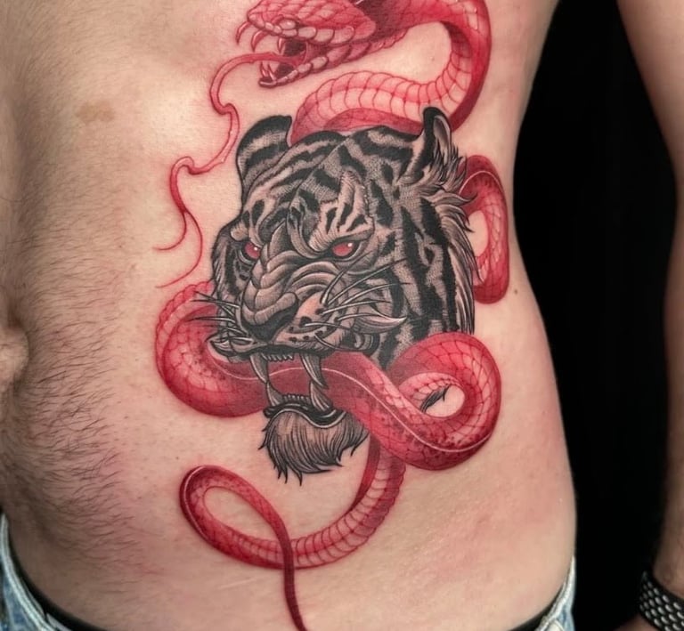 Tattoo of tiger with snake in red at Tattoo and body piercing studio in Vagos, Aveiro.