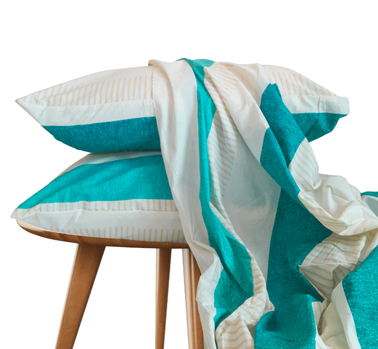 a stack of pillows and a bedsheet on a stool - cotton bedsheet