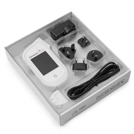 xprecia prime a pt inr meter with a white box and a charger