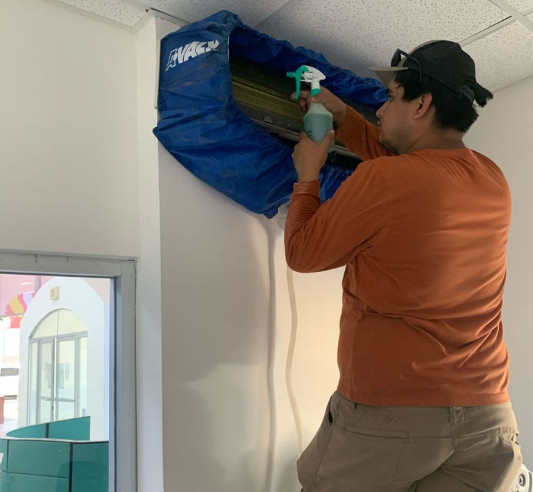 a man in a orange shirt is holding a blue bag