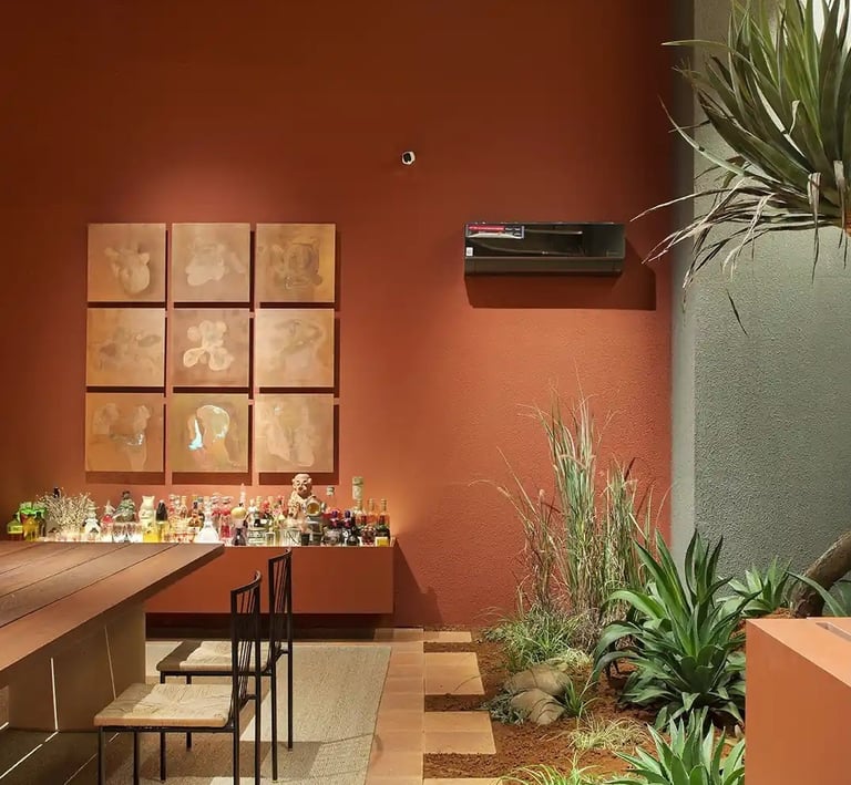 a dining room with a bar, table and chairs