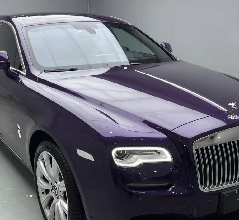 Hands carefully polishing a surface with purple and black tones softly blending.