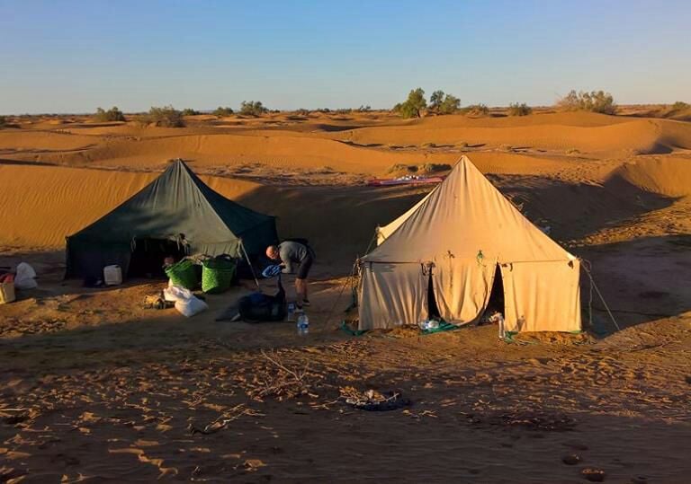 a group of people standing around a tent