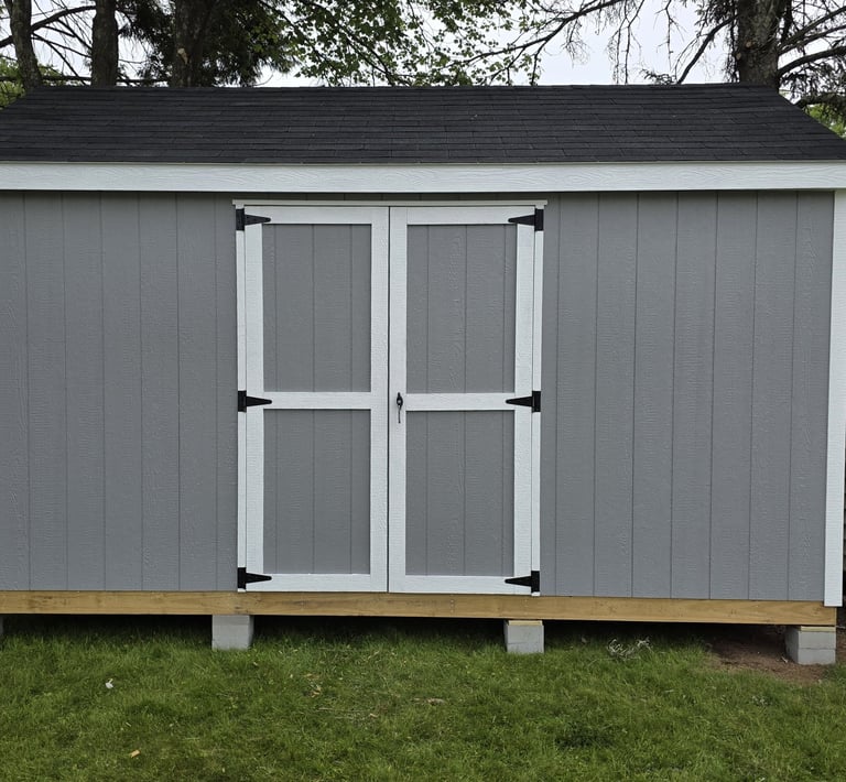 Custom 8x12 wooden shed built in Massachusetts, perfect for tools, equipment, and more.