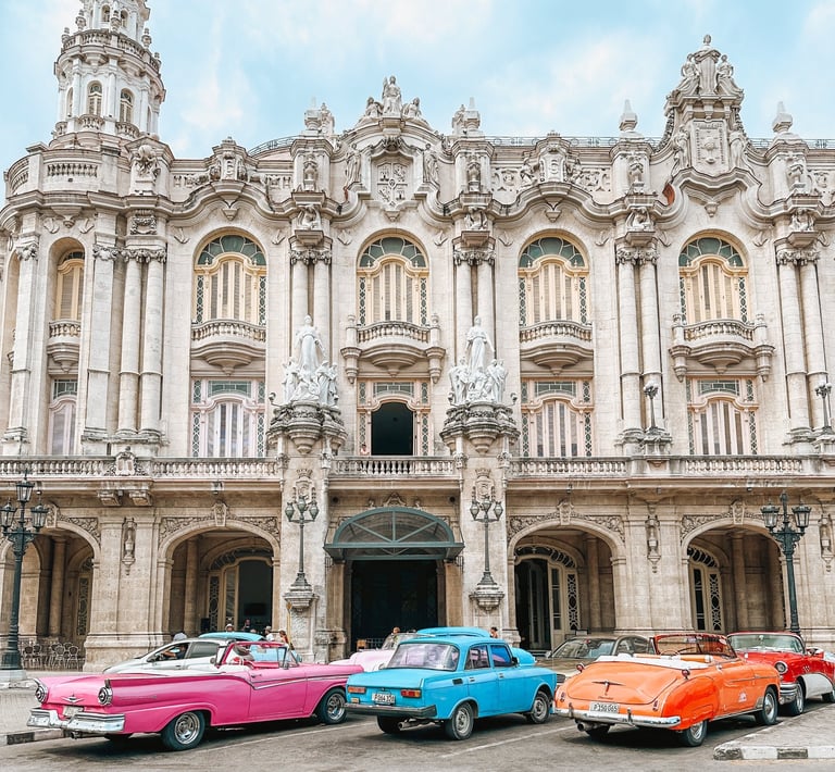 Classic cars parked in front of a building in Havana, Cuba