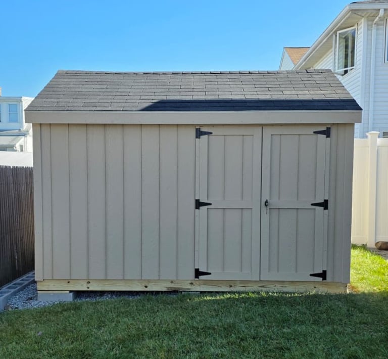 Custom 8x12 wooden shed built in Massachusetts, perfect for tools, equipment, and more.