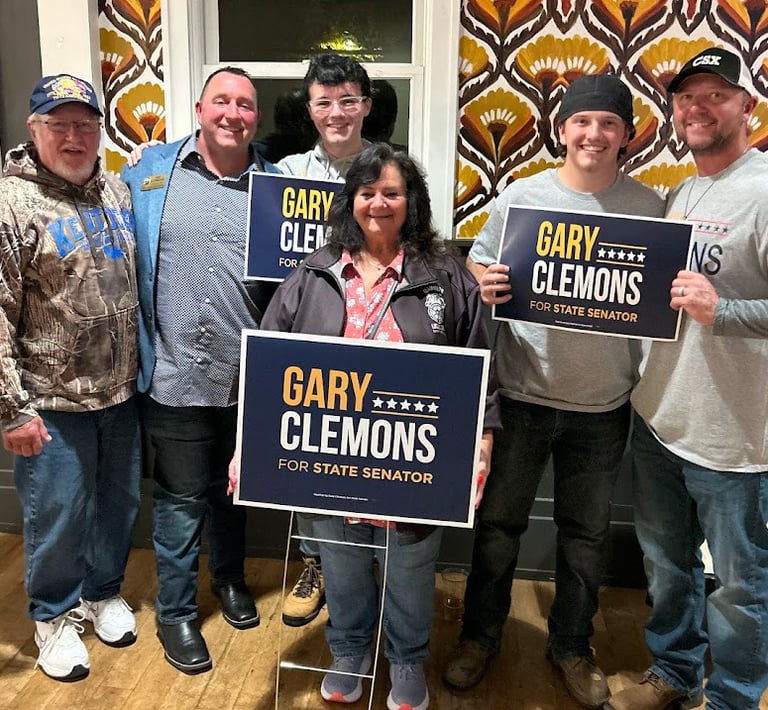 a group of people holding signs that read,'gary clemons, and