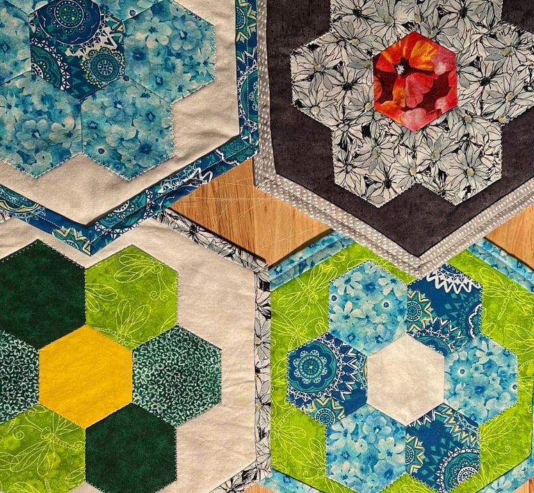a table with several quilted hexagons