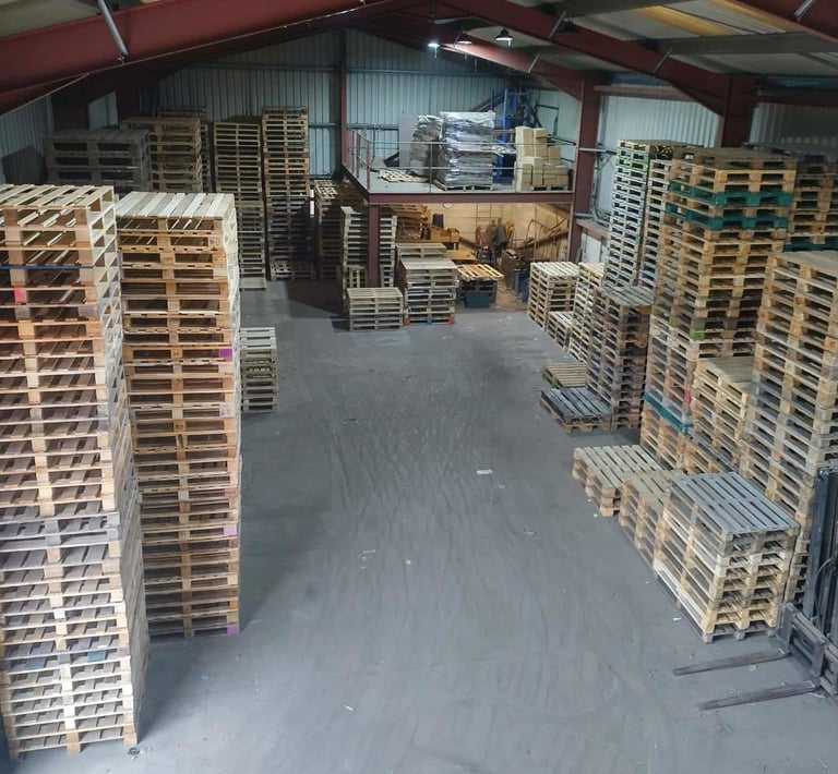 Warehouse with repaired pallets stacked up