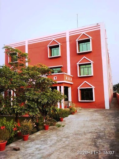 a red building with a tree in the foreground