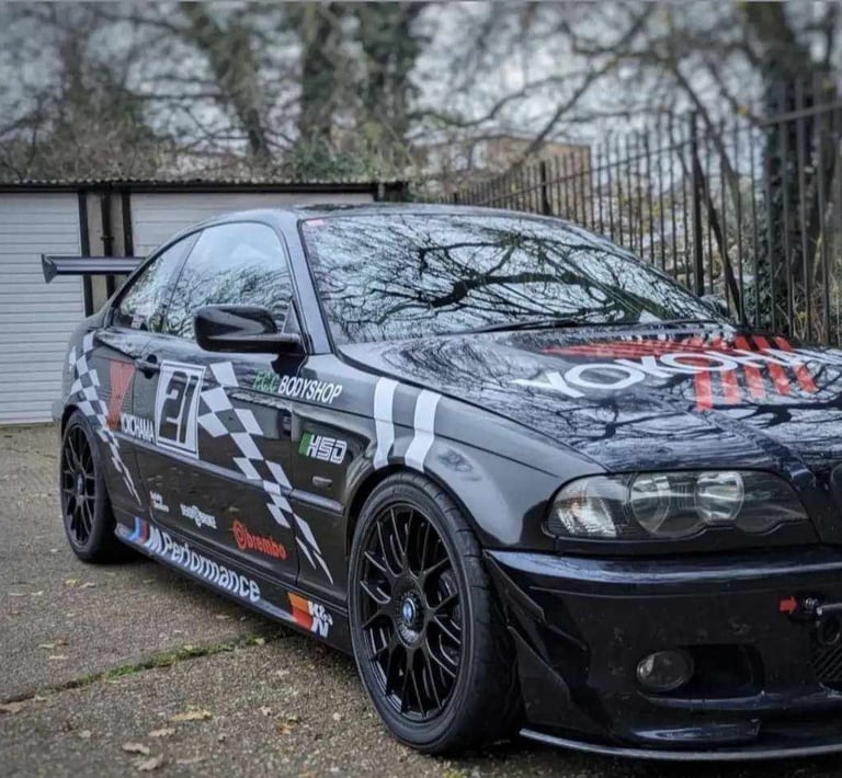 a black and white car with a graffiti on it