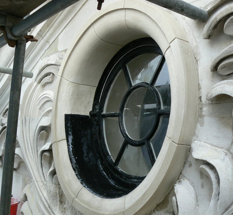 a newly restored portland stone circular window with a circular window in a building