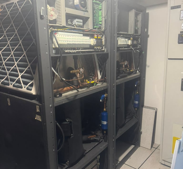 Industrial HVAC control panel and electrical cooling units inside a server room data center.