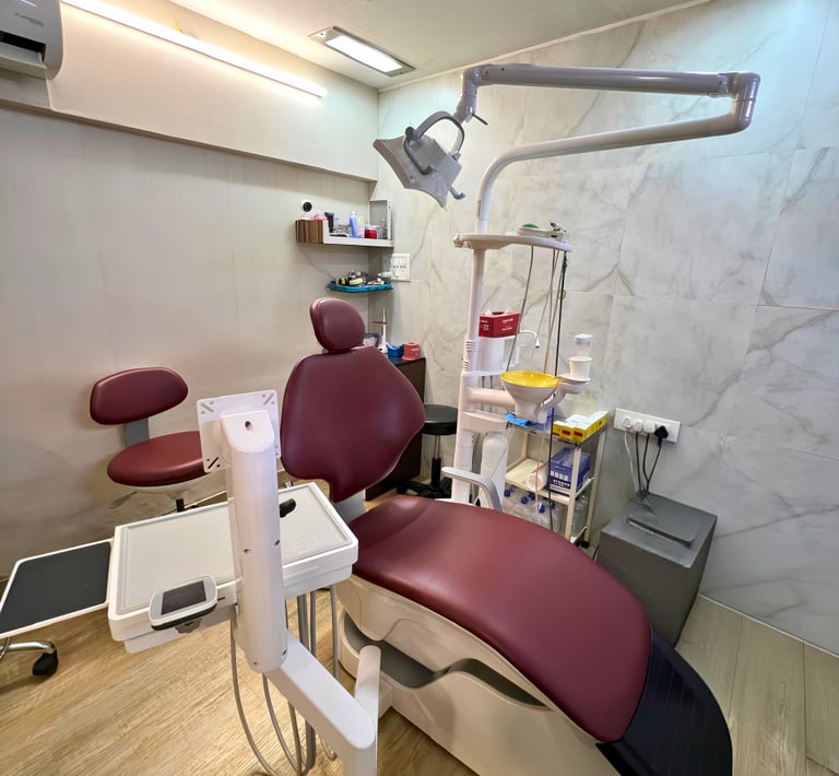 Modern dental clinic interior featuring a maroon examination chair and professional dentistry equipment.