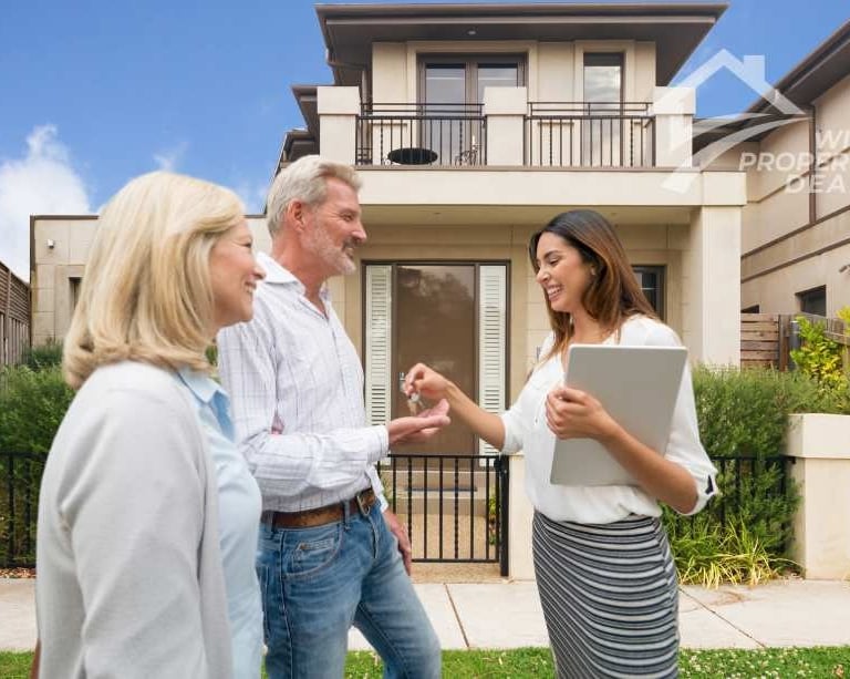 a couple and their family standing in front of a house