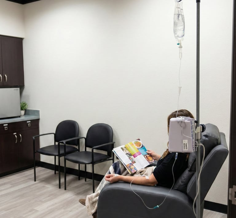 Patient receiving IV infusion therapy while seated in a comfortable recliner in a neurology clinic.
