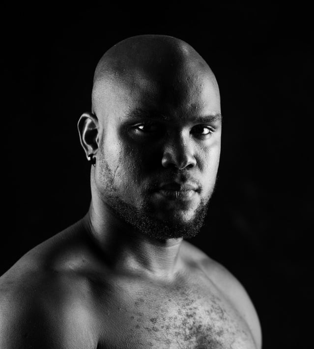 Bald Headshot Of Melvin Dain 