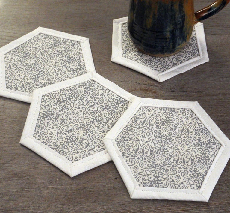 a mug of coffee on hexagon shaped fabric coasters