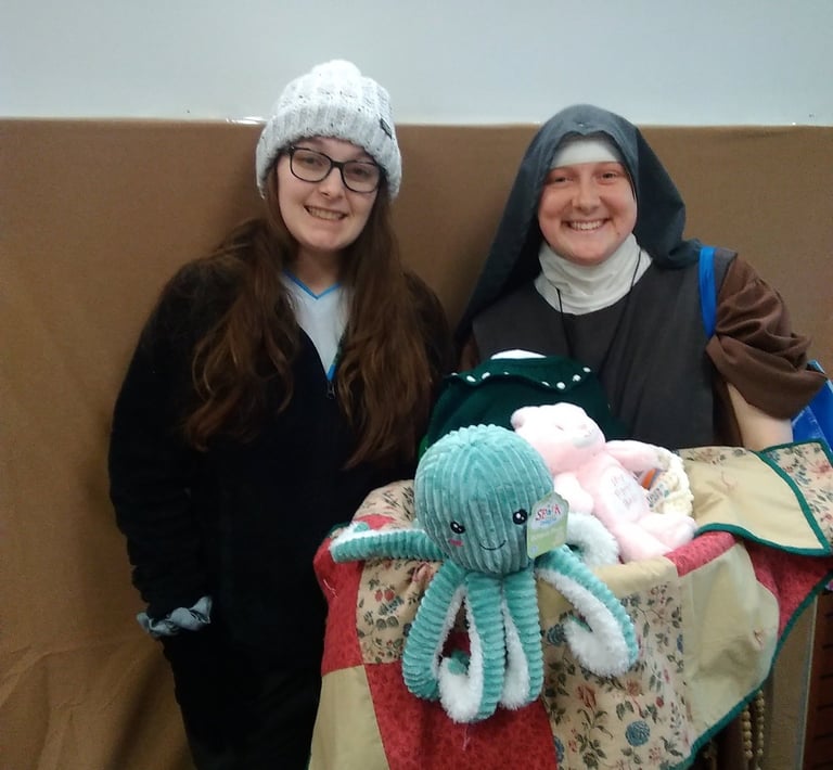 A mom receives a new baby welcome basket at the Rose Garden Mission