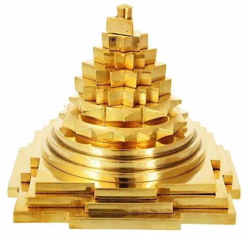 The image shows the Meru Shree Yantra, also known as the Shri Yantra, crafted primarily from brass.