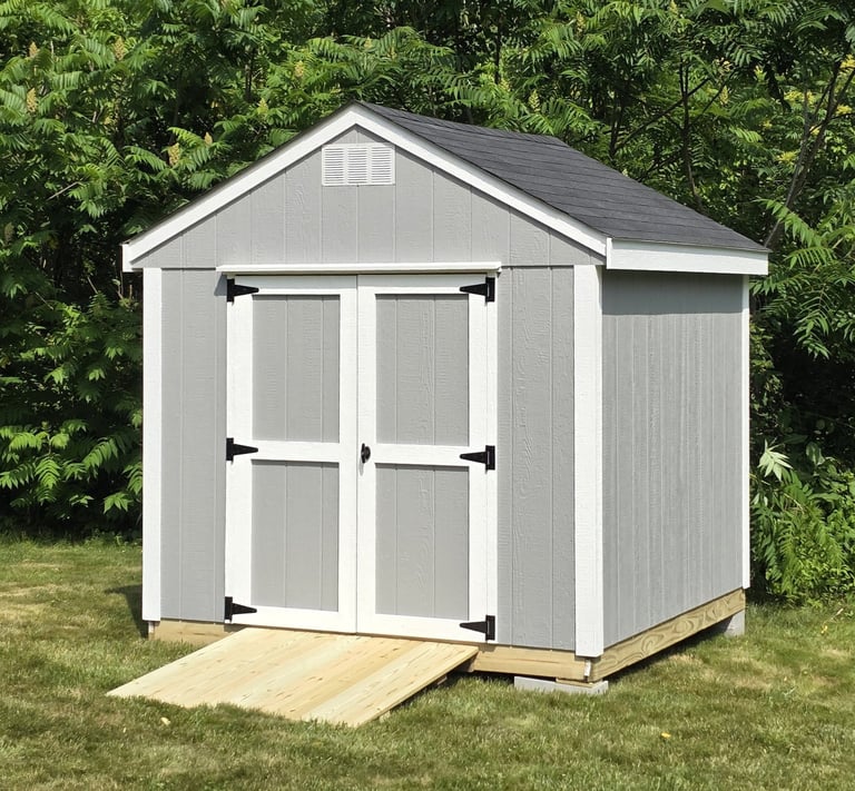 Custom wooden shed built in Massachusetts, perfect for garden tools and storage.