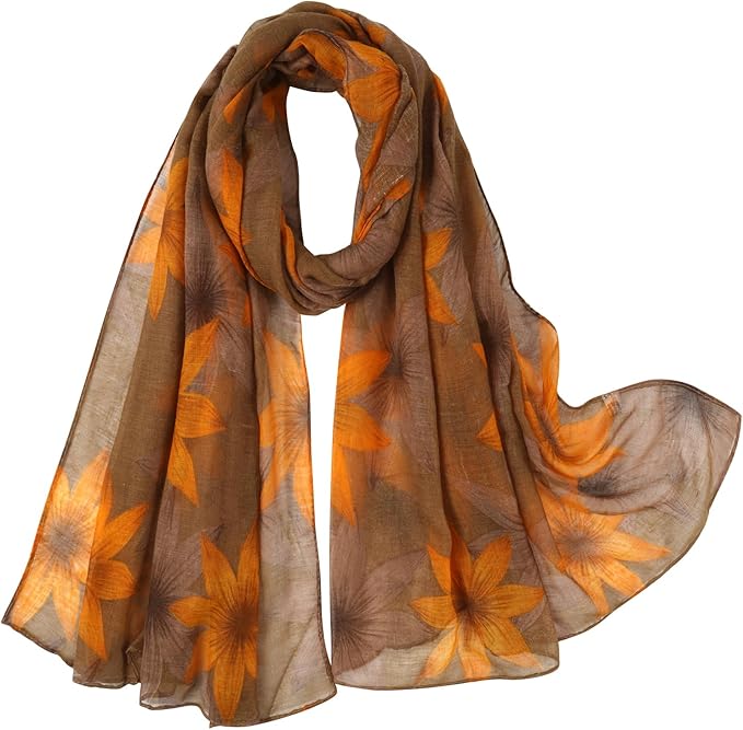 Lightweight floral leaf print fall scarf in brown-yellow tones, styled as a shawl or wrap.