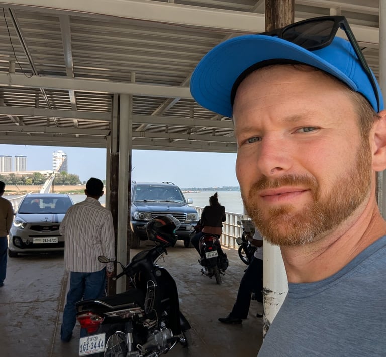 a selfie of Don on a river ferry crossing the Tonle Sap River in Cambodia