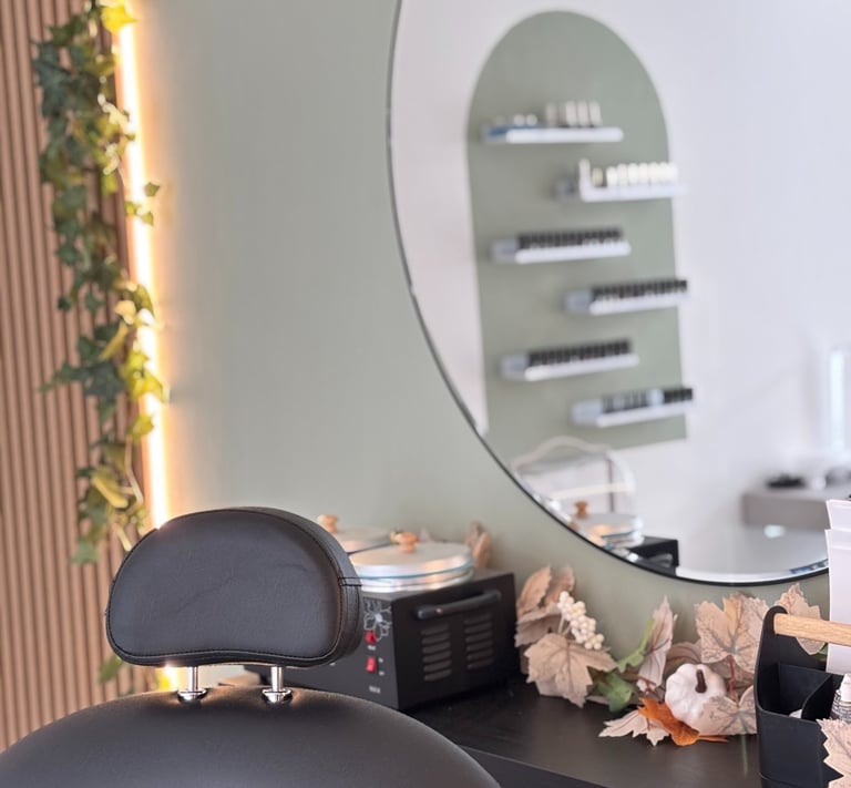 Black beauty chair with a mirror and studio behind.