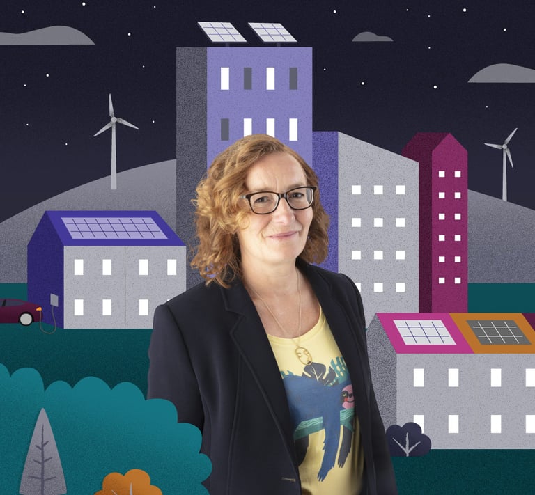 Women sits in front of an illustrated scene of colourful a town with hills and wind turbines.