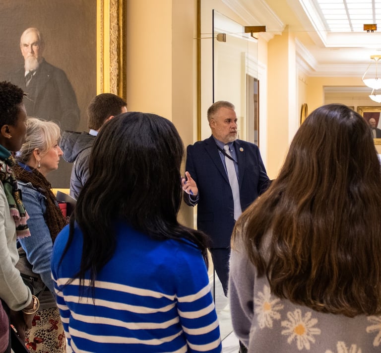 Tim Nangle at Maine State House with visiting high school students and teachers