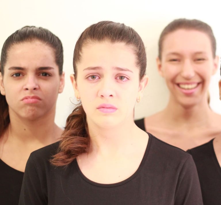 a group of people standing in front of a white wall