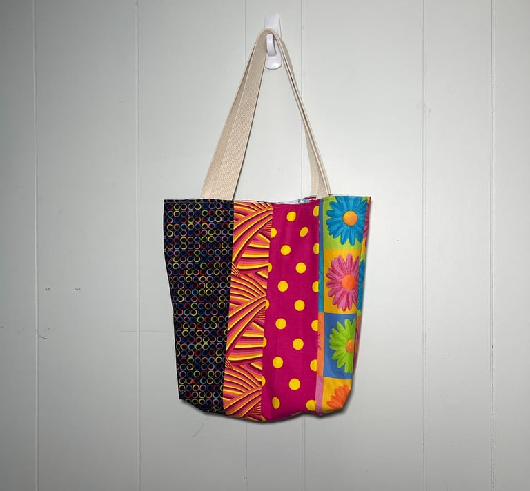  a colorful patchwork bag hanging on a wall
