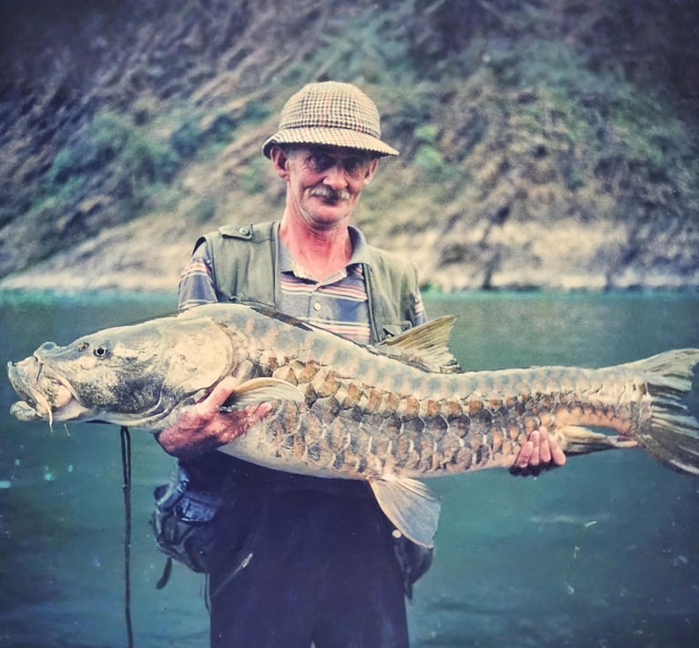 Legendary angler Christopher Oldmeadow holding a Golden Mahseer.