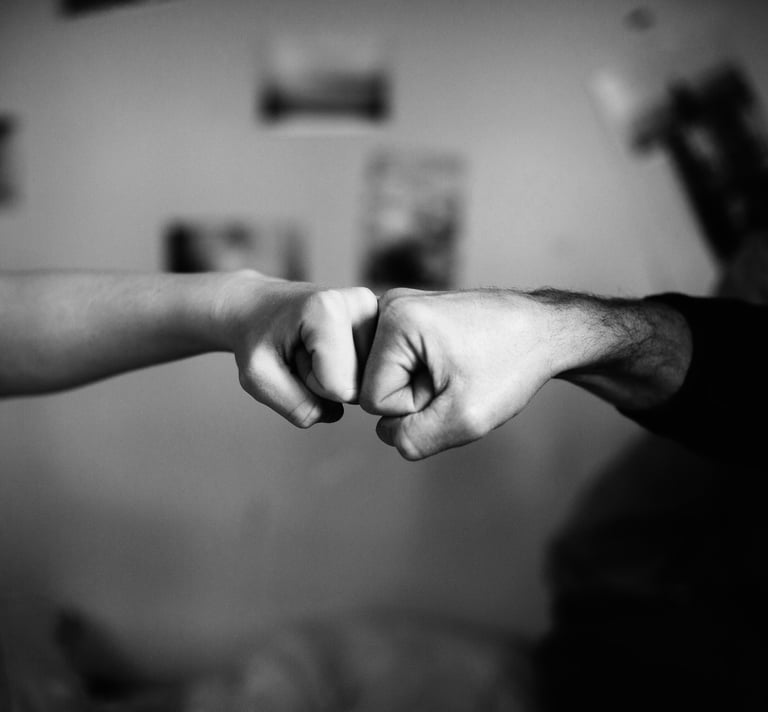 black and white photo of a fist bump