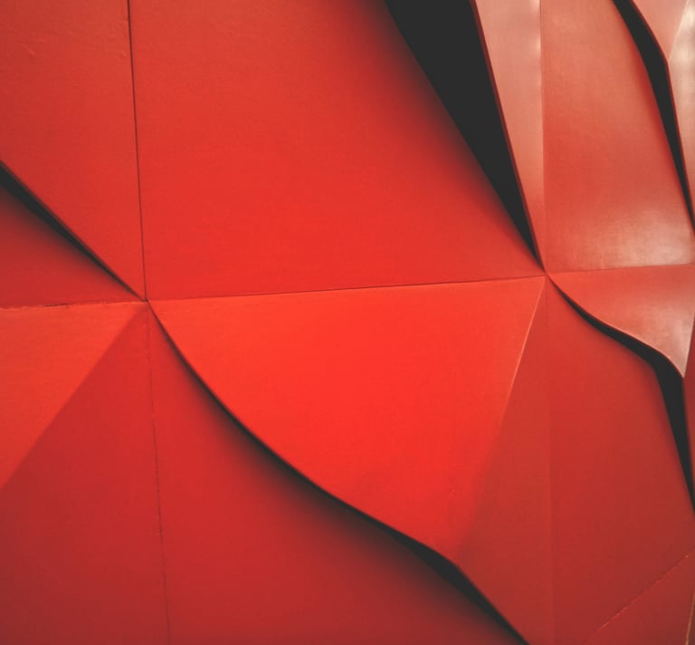 a red wall with large wavered wallpapered structure