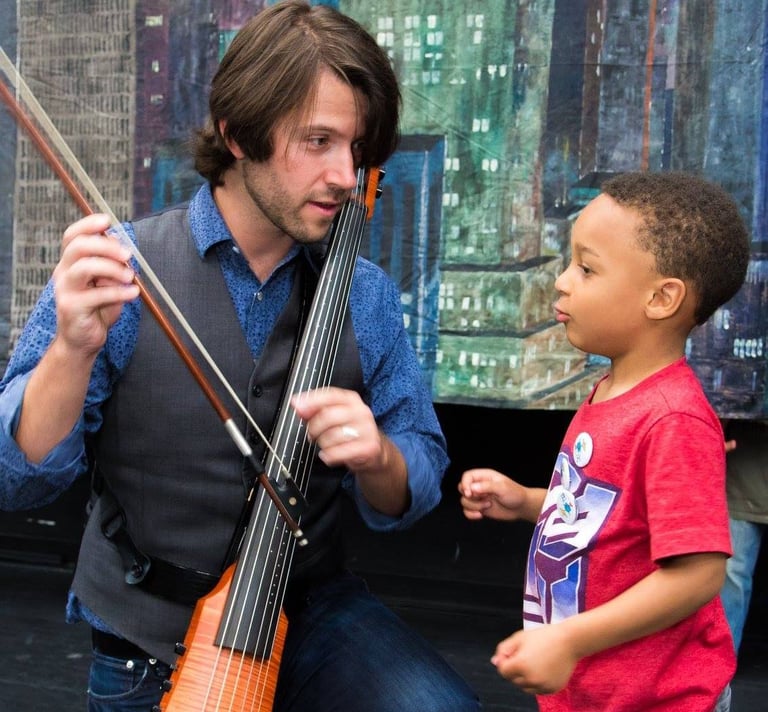 cellist Wytold works with a student