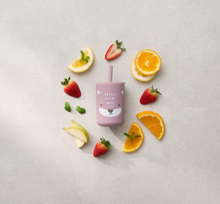 Product photography - a kids cup in the middle of fruit