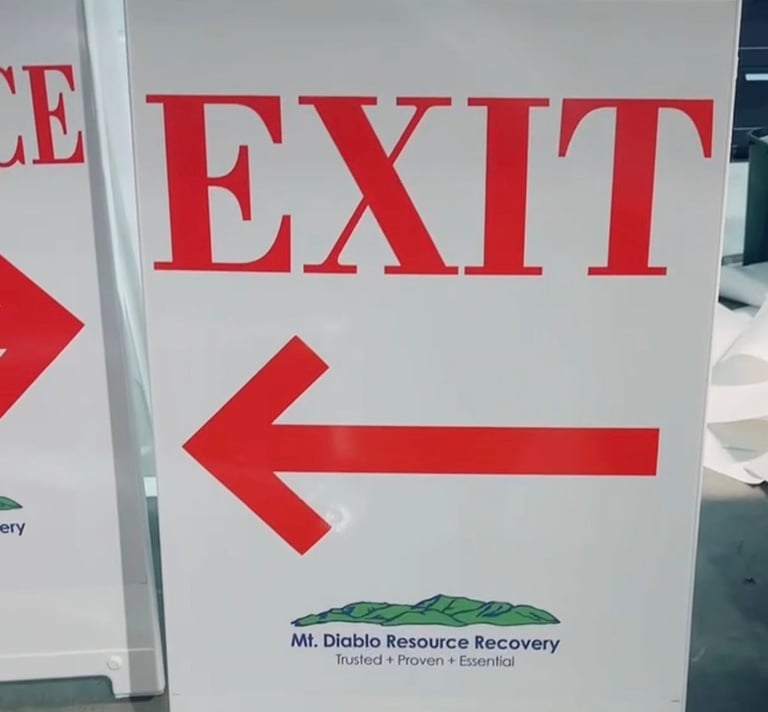 Mt. Diablo Resource Recovery white exit sign with a red directional arrow pointing left.