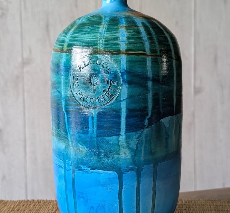Handcrafted blue and green glazed ceramic bottle vase with rustic drip texture and embossed French stamp.