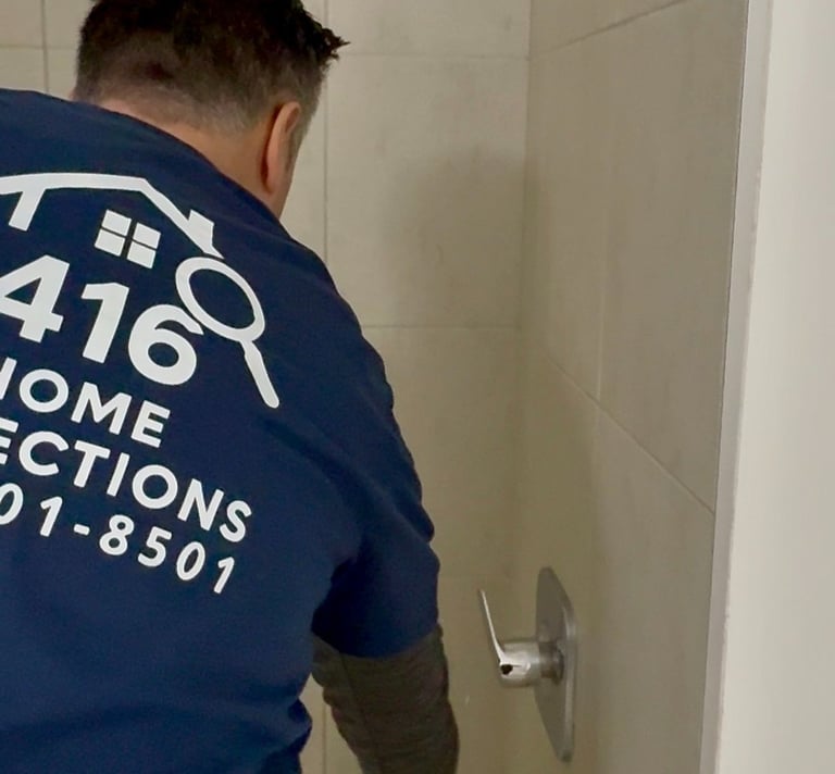 Professional home inspector checking a bathtub faucet and shower fixtures for water pressure and leaks.