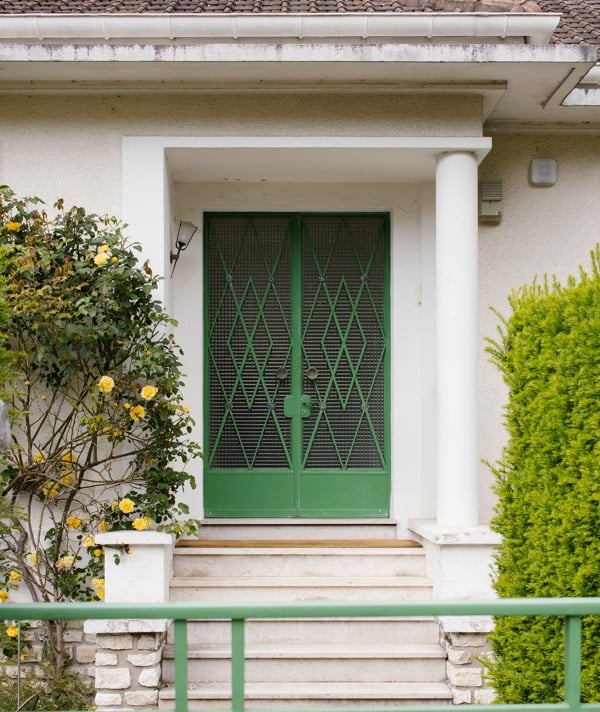 a green door with a green gate and a green gate