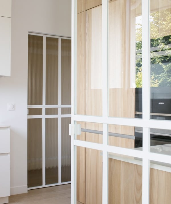 a kitchen with a wooden floor and a white cabinet