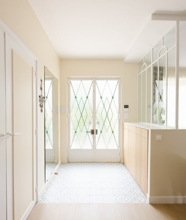 a hallway with a large window and a door